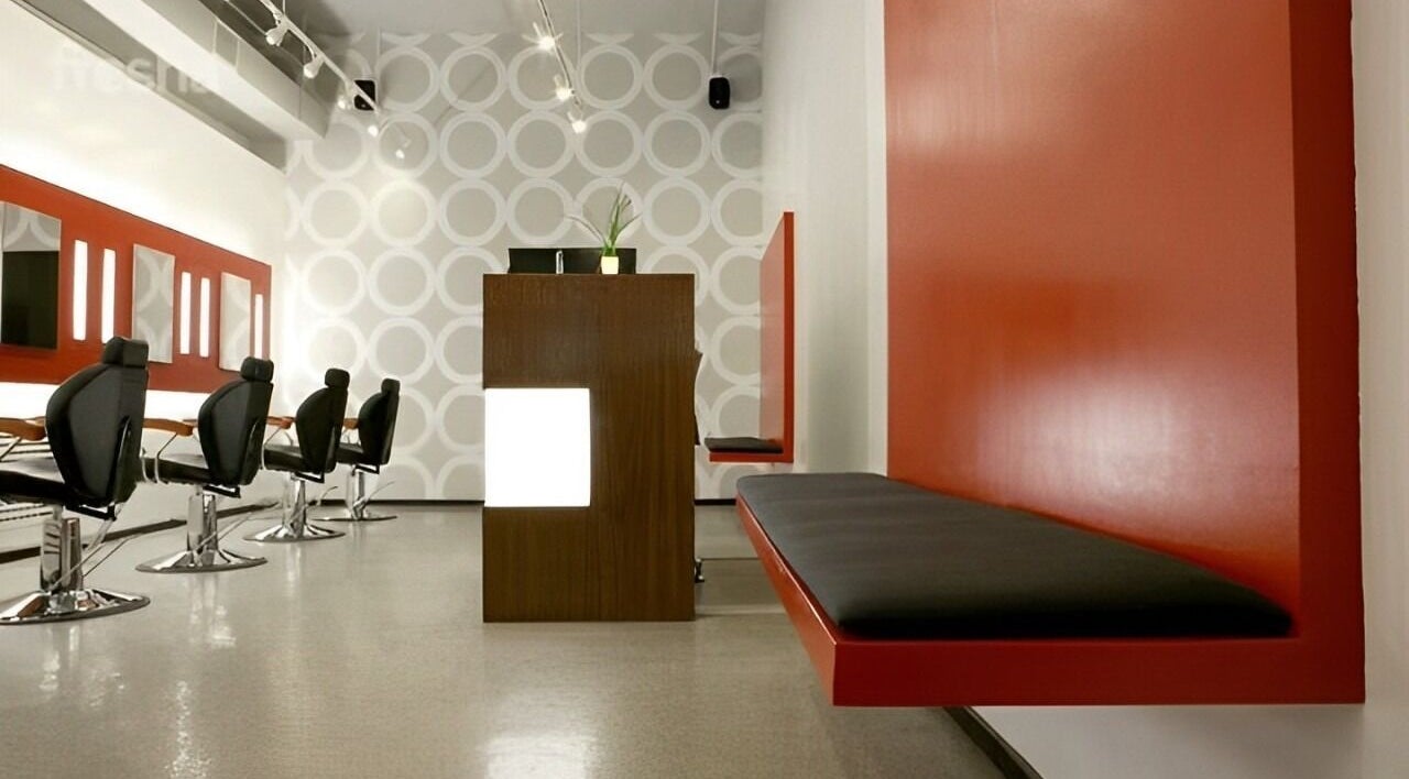 Chic interior of Thread - Financial District, New York, New York, US with sleek black chairs and red accents.