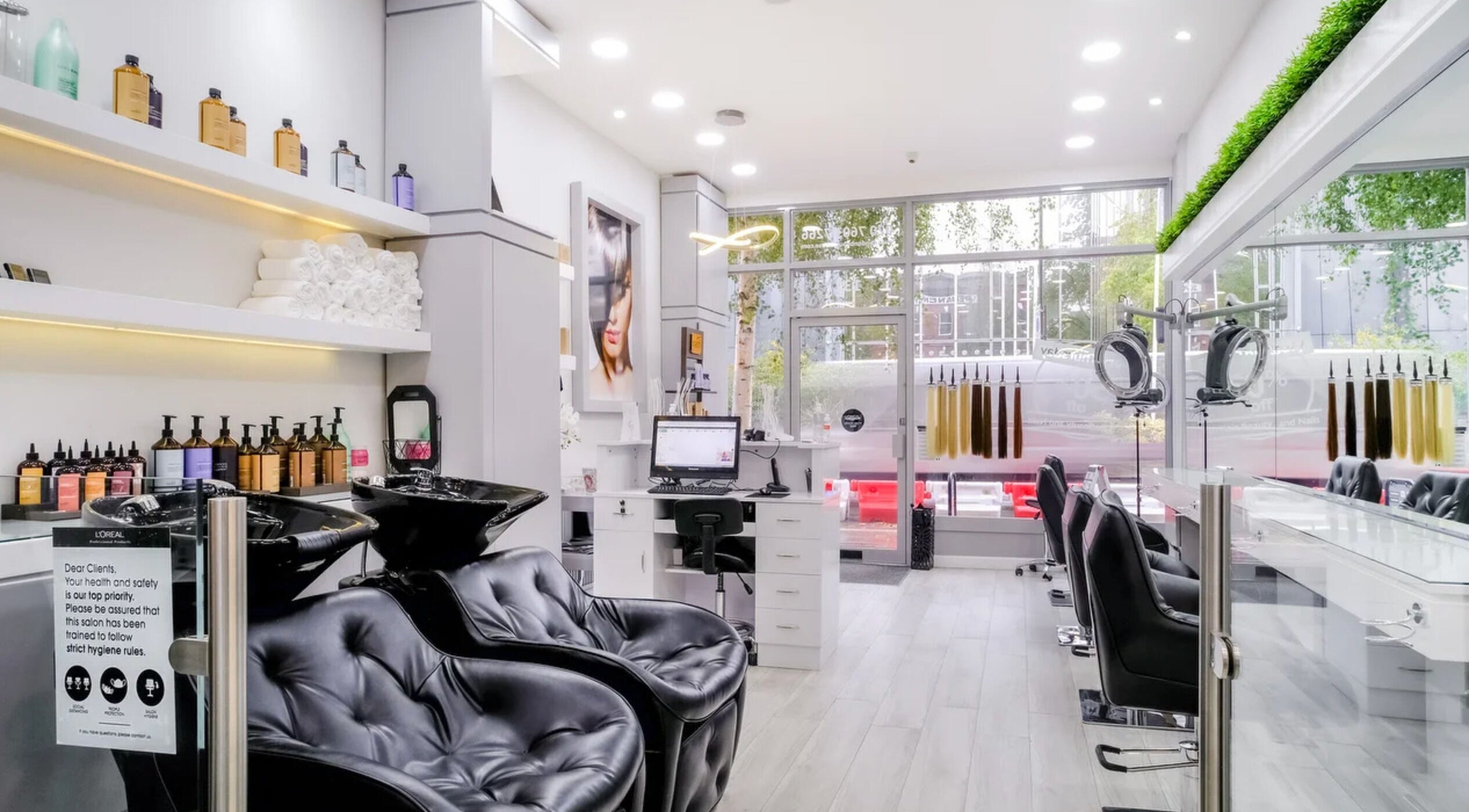 Bright, modern salon interior at London Beauty House, London, England, GB, with sleek chairs and hair products.