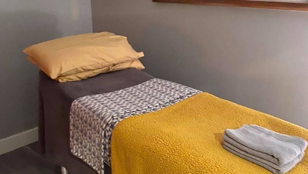 Relaxing massage bed at Holistic Approach in Carrickfergus, Northern Ireland, GB, showcasing comfort and warmth.