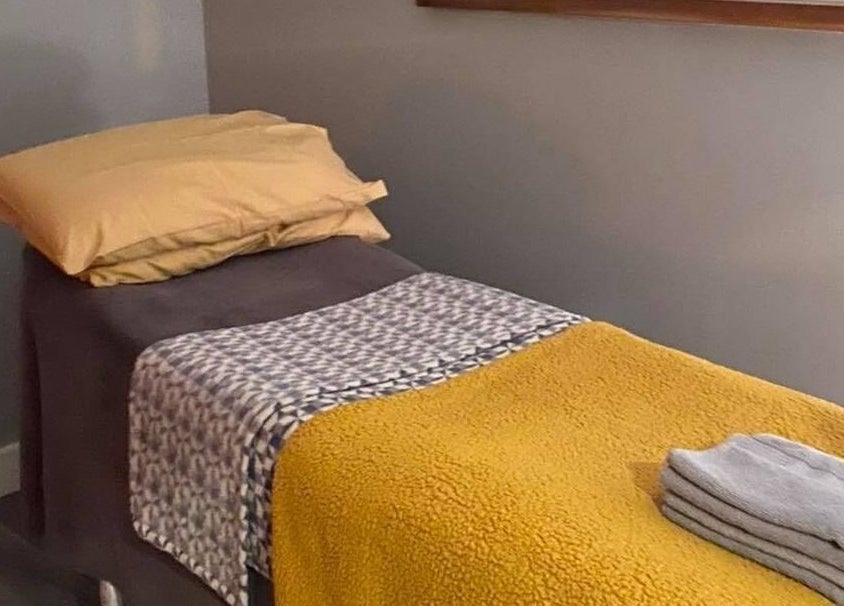 Relaxing massage bed at Holistic Approach in Carrickfergus, Northern Ireland, GB, showcasing comfort and warmth.