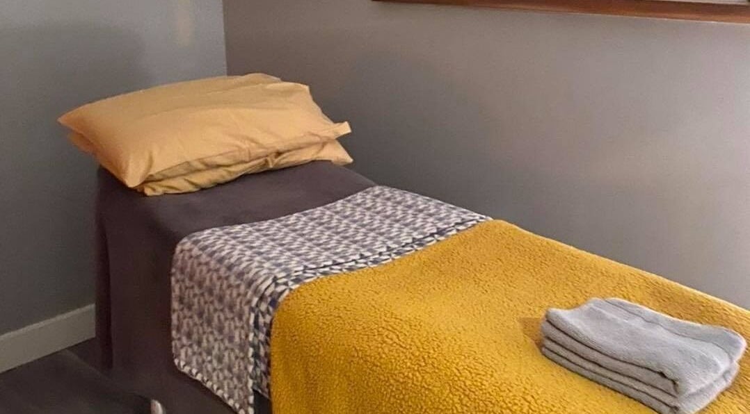 Relaxing massage bed at Holistic Approach in Carrickfergus, Northern Ireland, GB, showcasing comfort and warmth.