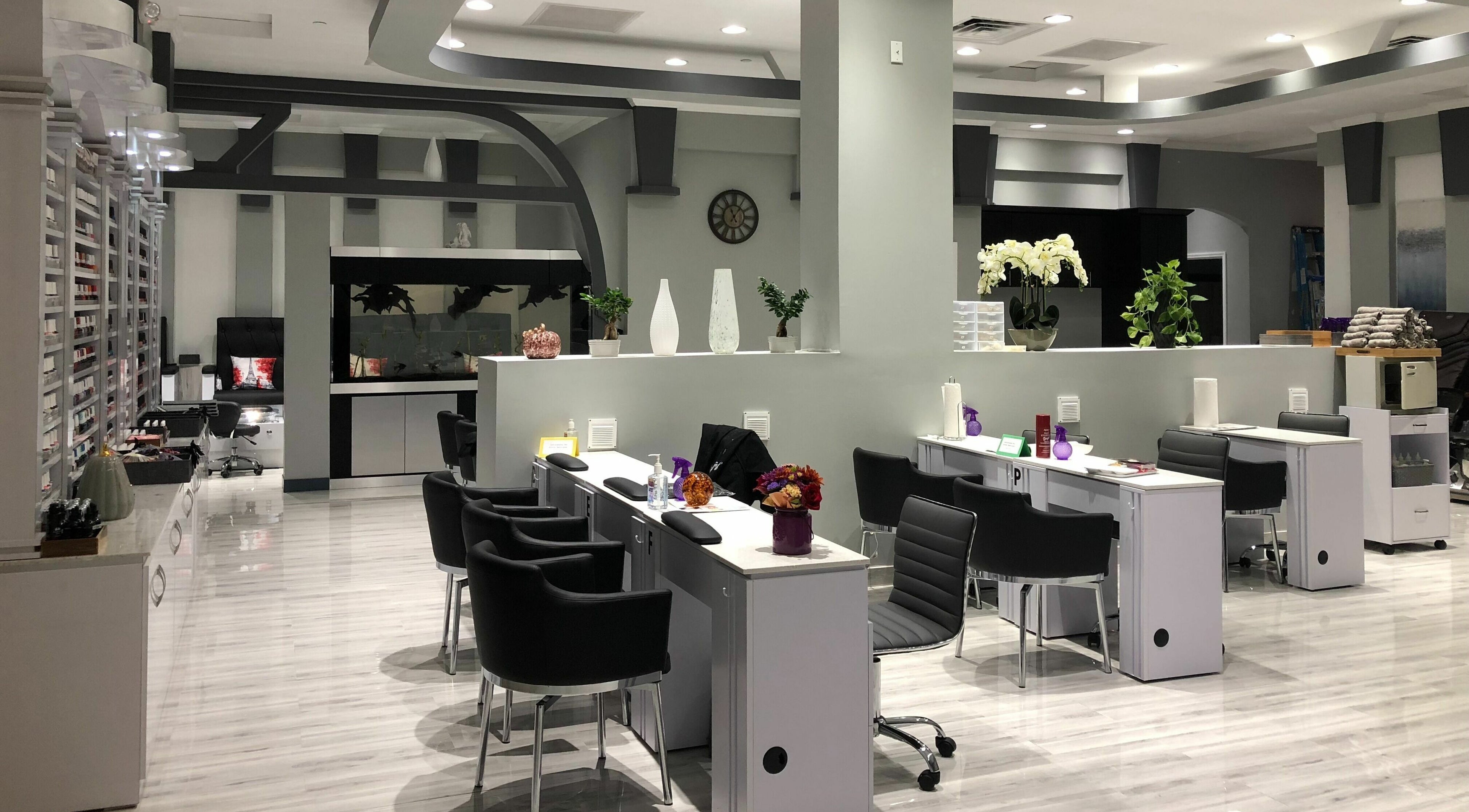 Stylish interior of J'adore Nail Bar, Largo, Florida with modern nail stations and elegant decor.