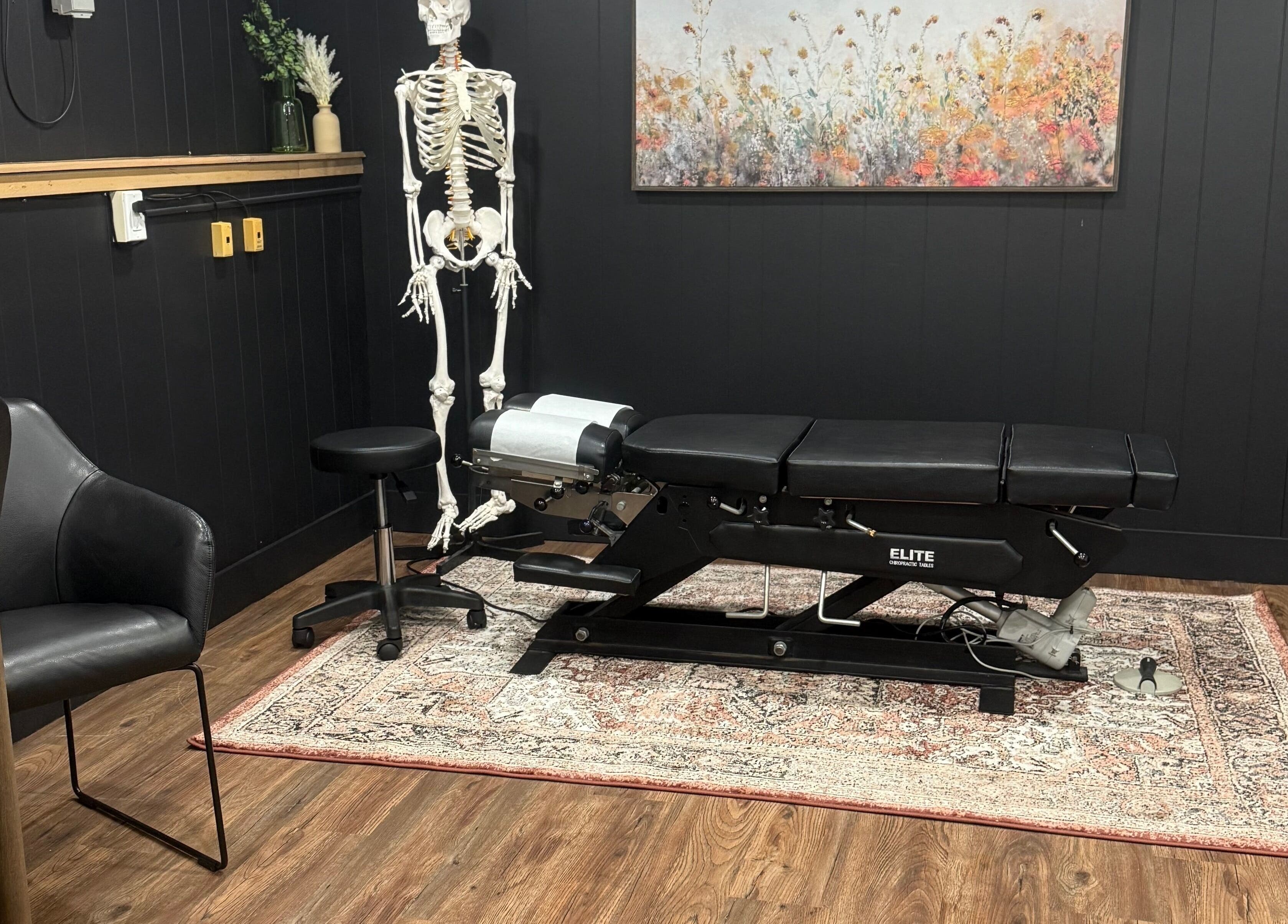 Therapy room at Beauty Basics by Amy with black massage table, Minden, Ontario, CA.