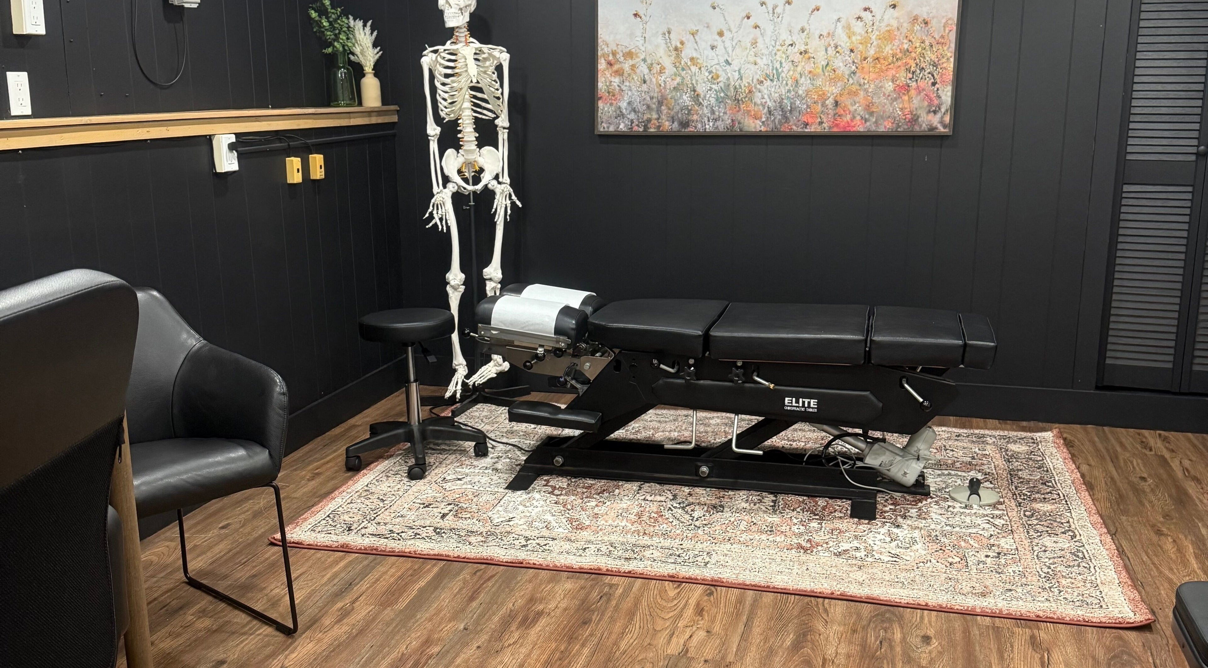 Therapy room at Beauty Basics by Amy with black massage table, Minden, Ontario, CA.