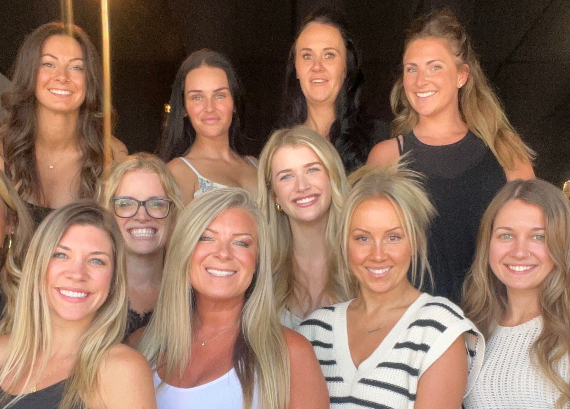 Team of stylists at Beauty Basics by Amy, Minden, Ontario, CA smiling and posing together.