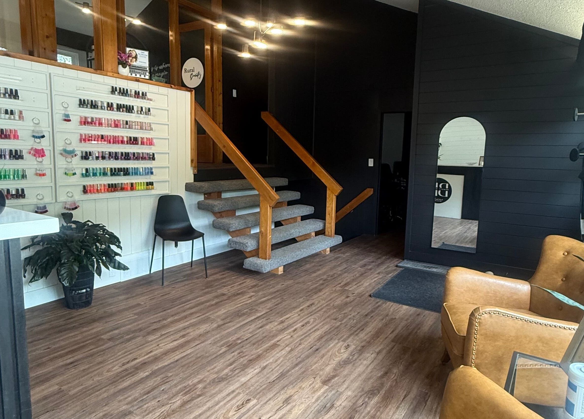 Spacious, modern interior at Beauty Basics by Amy in Minden, Ontario, CA featuring stylish seating and nail polish display.
