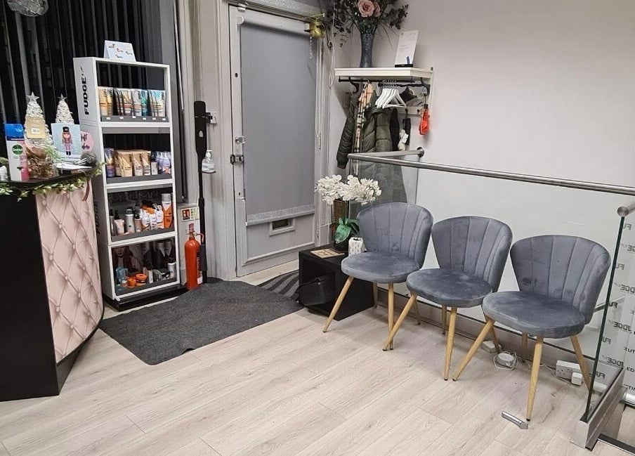 Elegant reception area at The Cutting Edge, Dumfries, Scotland, GB, featuring modern chairs and product display.