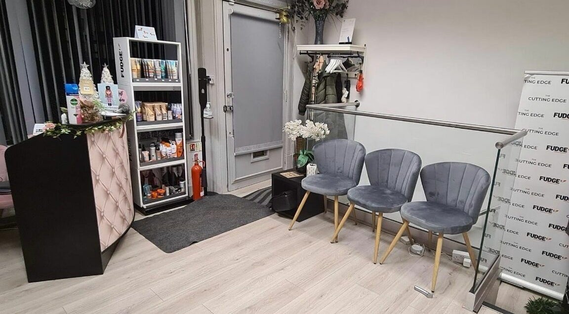 Elegant reception area at The Cutting Edge, Dumfries, Scotland, GB, featuring modern chairs and product display.