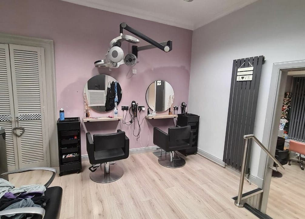 Modern salon interior at The Cutting Edge, Dumfries, Scotland, GB with stylish chairs and mirrors.
