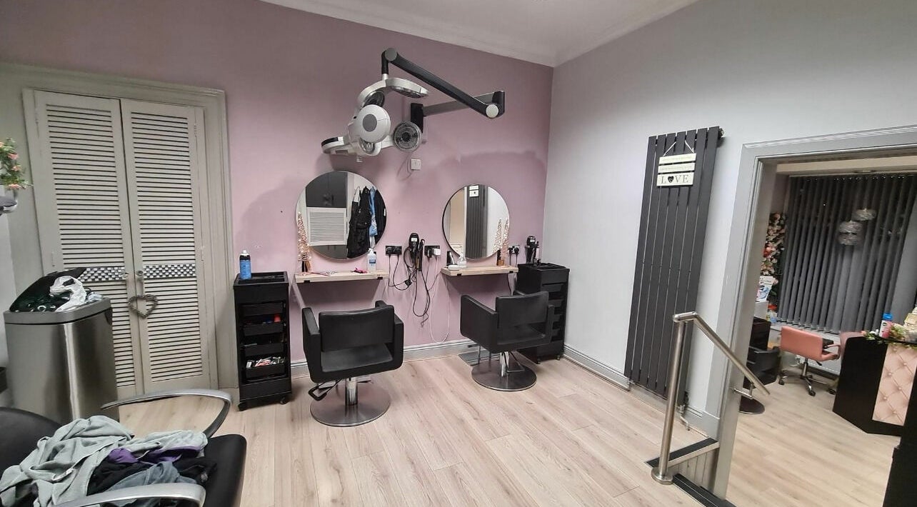 Modern salon interior at The Cutting Edge, Dumfries, Scotland, GB with stylish chairs and mirrors.