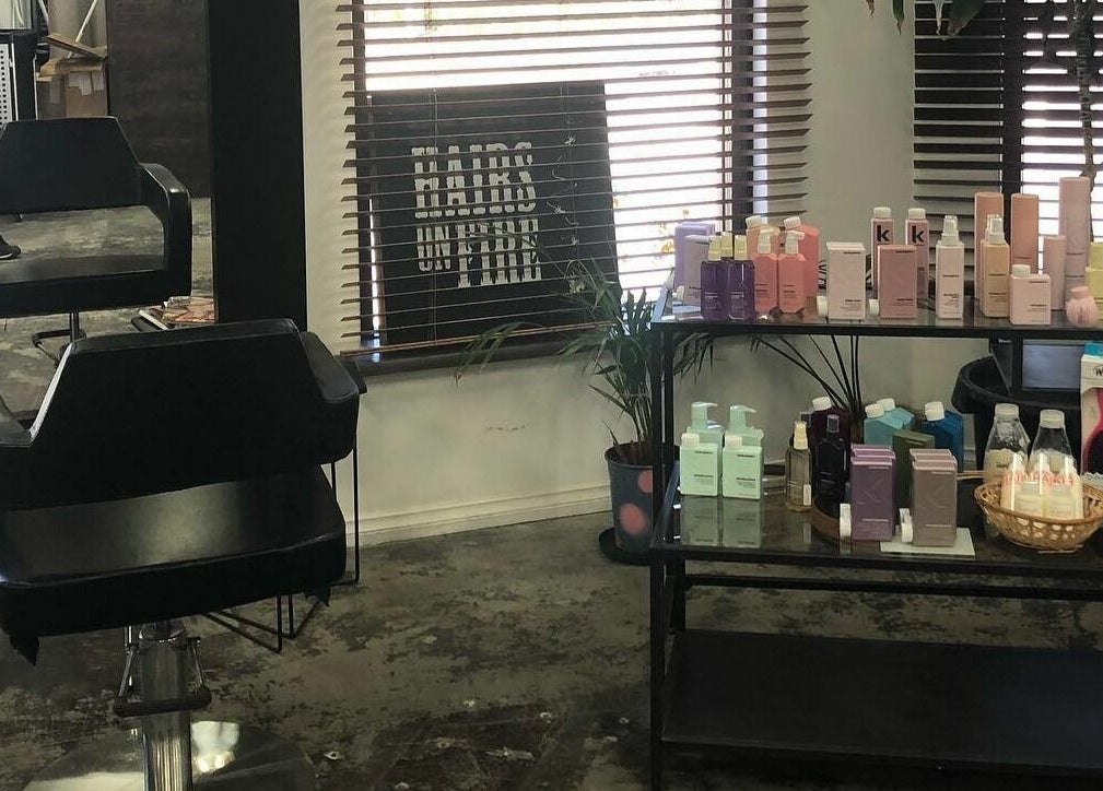Inside Hairs on Fire salon in Fremantle, Western Australia, AU featuring a styling chair and beauty products.