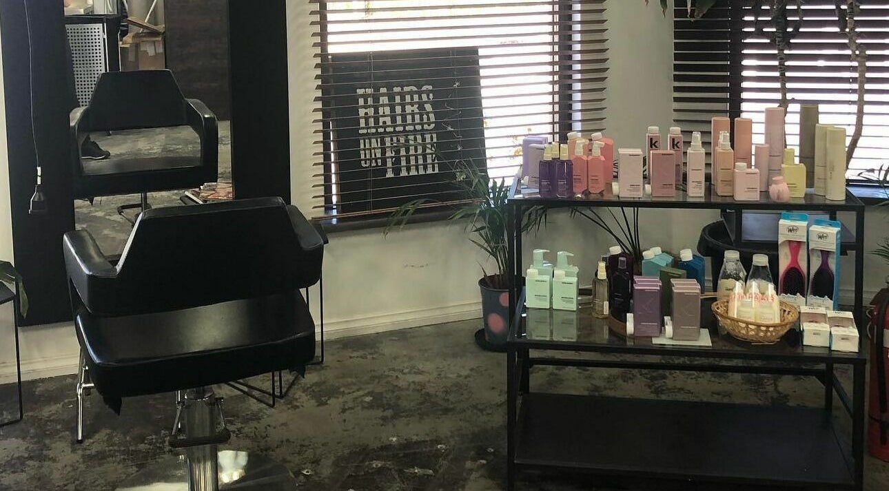 Inside Hairs on Fire salon in Fremantle, Western Australia, AU featuring a styling chair and beauty products.