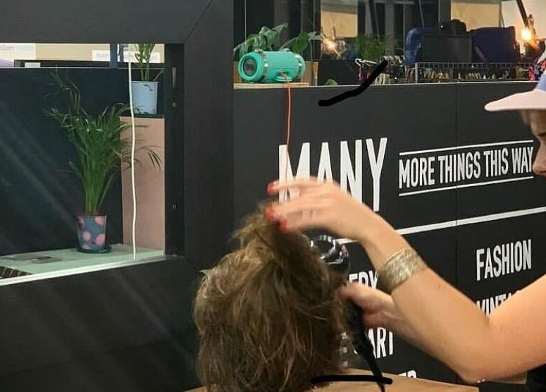 Hairdresser styling at Hairs on Fire, Fremantle, Western Australia, AU. Modern chic setting with vibrant decor.