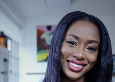 Smiling woman at Zateesha Barbour in London, England, GB, showcasing vibrant hair and makeup.