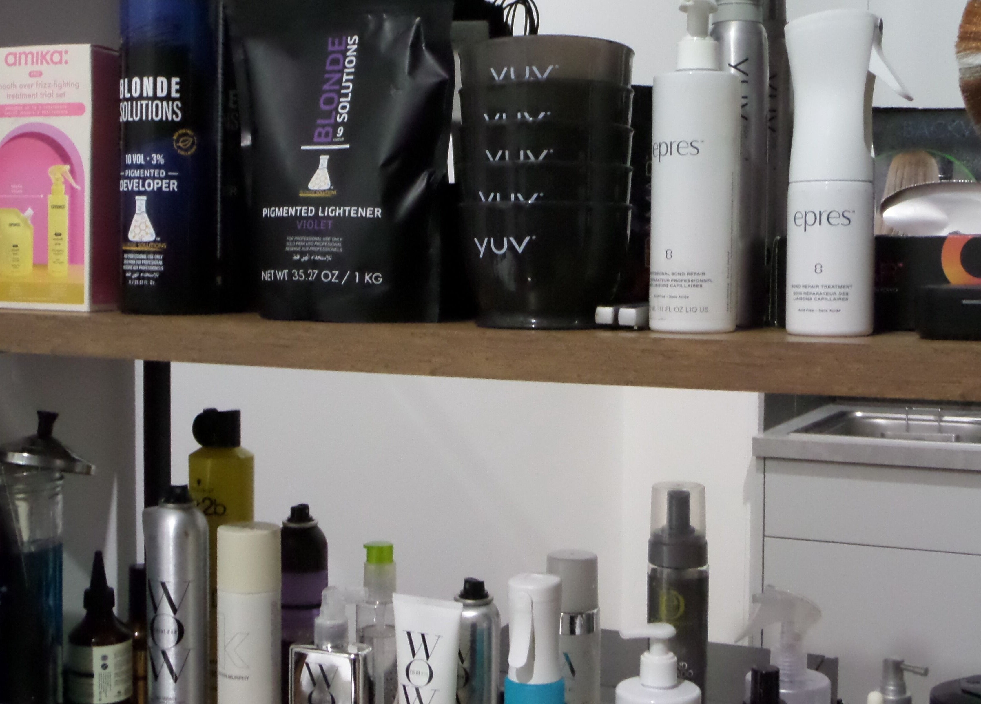 Beauty products on a salon shelf at Zateesha Barbour, London, England, GB showcasing professional hair care.