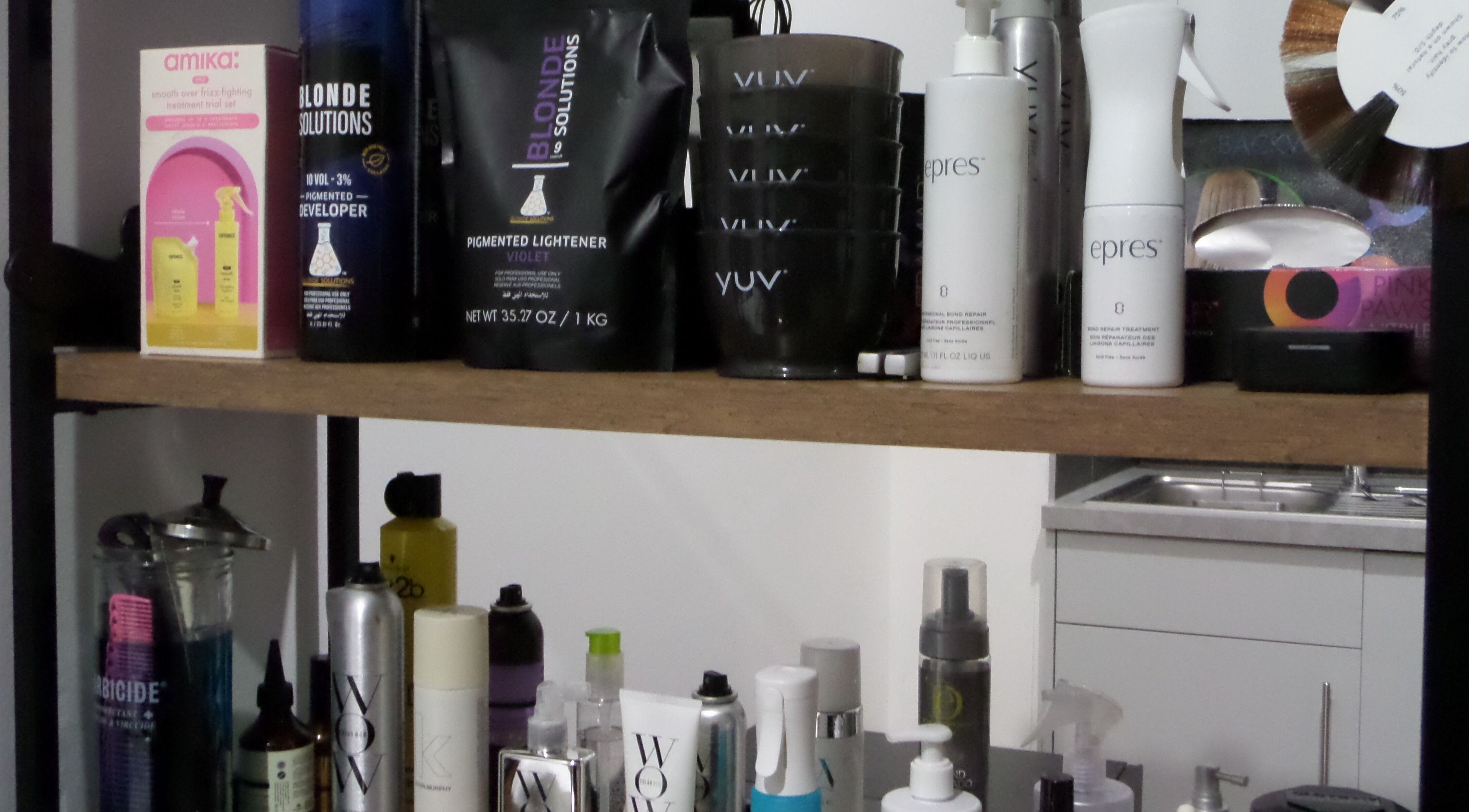 Beauty products on a salon shelf at Zateesha Barbour, London, England, GB showcasing professional hair care.
