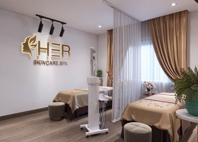 Relaxing spa room at Her Hải Phòng, Hải Phòng, VN, featuring elegant decor and two treatment beds.