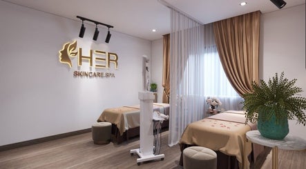 Relaxing spa room at Her Hải Phòng, Hải Phòng, VN, featuring elegant decor and two treatment beds.