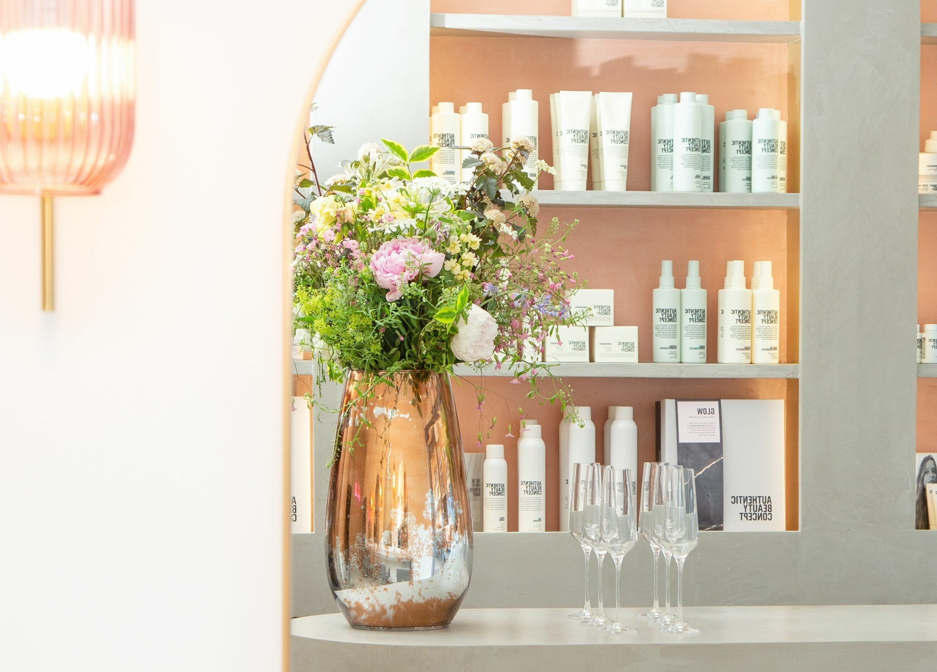Elegant floral display at Wavi London, a beauty venue in London, England, GB with stylish product shelves.