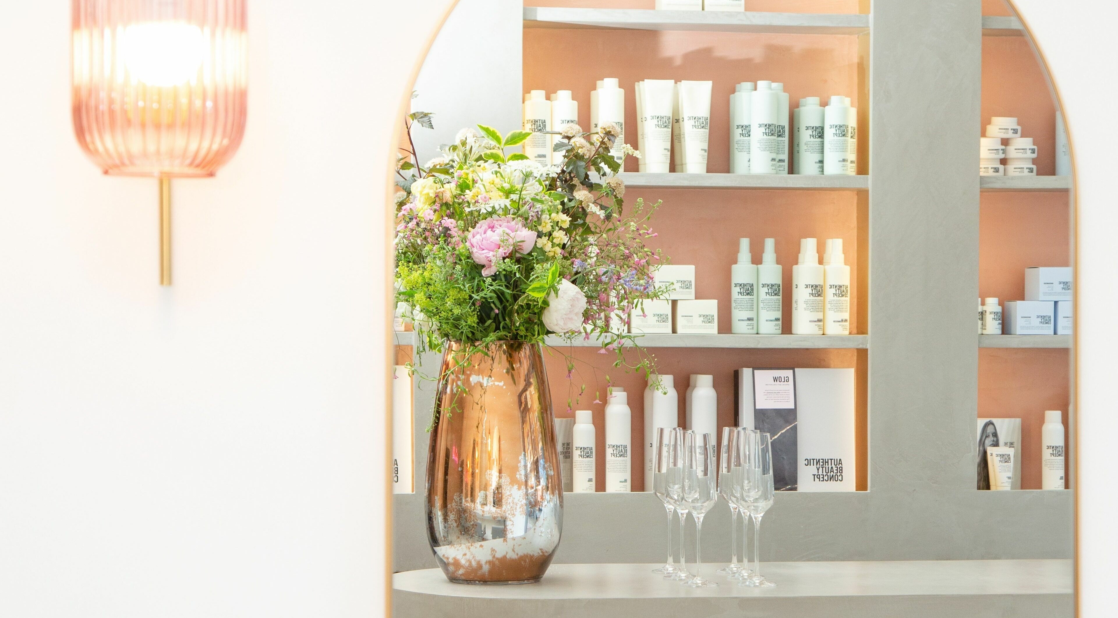 Elegant floral display at Wavi London, a beauty venue in London, England, GB with stylish product shelves.