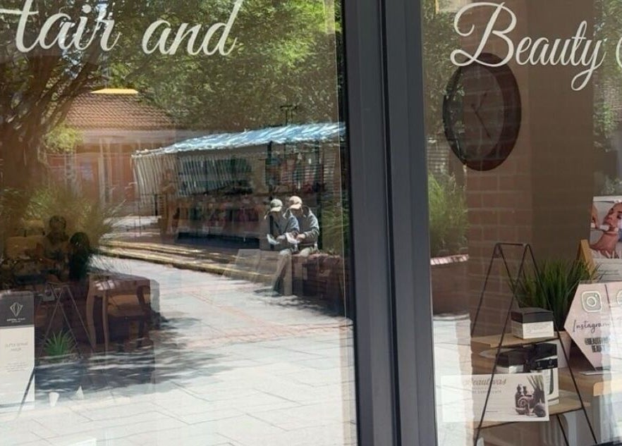 Elegant front of Beautevas Beauty and Tanning in Martlesham, England, GB reflecting a bustling street.