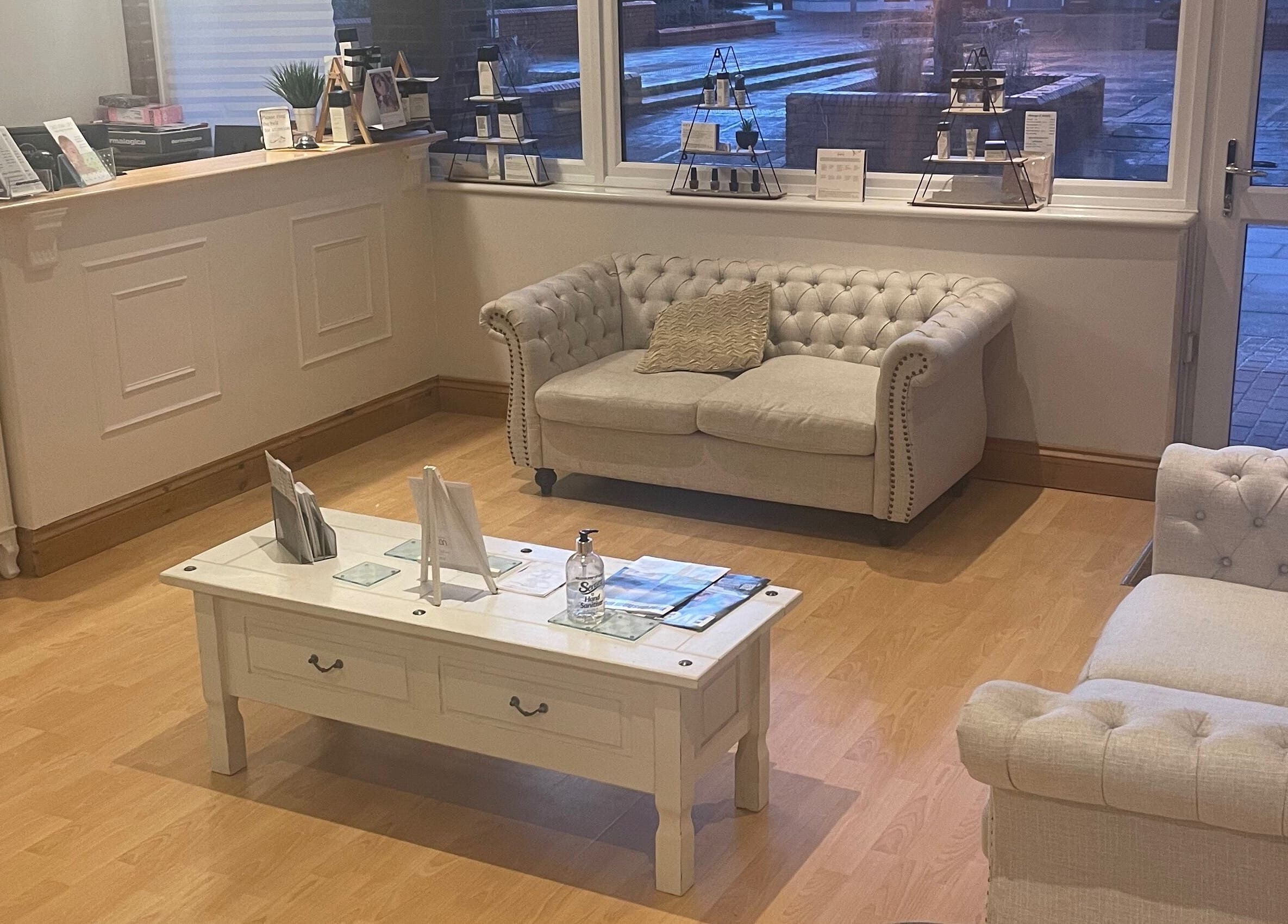 Cozy reception lounge at Beautevas Beauty and Tanning in Martlesham, England, GB with plush sofas and a coffee table.