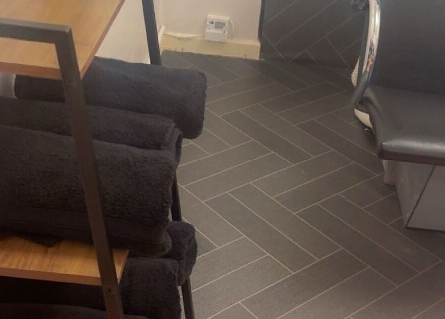 Cozy black towels neatly stacked at Beautevas Beauty and Tanning in Martlesham, England, GB.