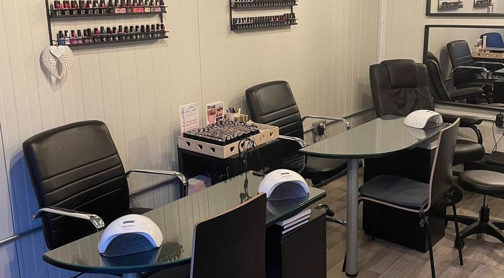 Modern nail studio at Polished of Swinton, Swinton, England, GB with sleek black chairs and polish display.
