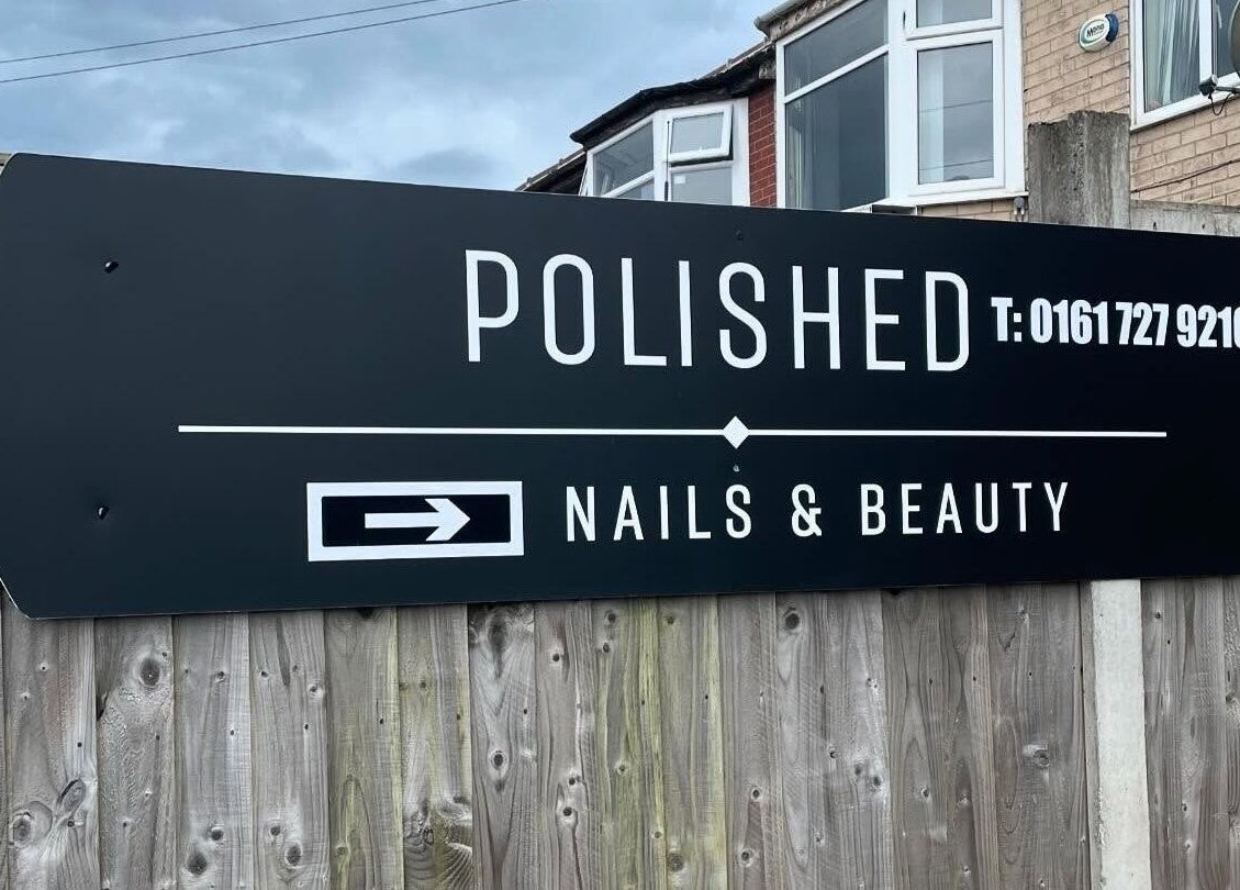 Polished of Swinton venue sign on a wooden fence, Swinton, England, GB.