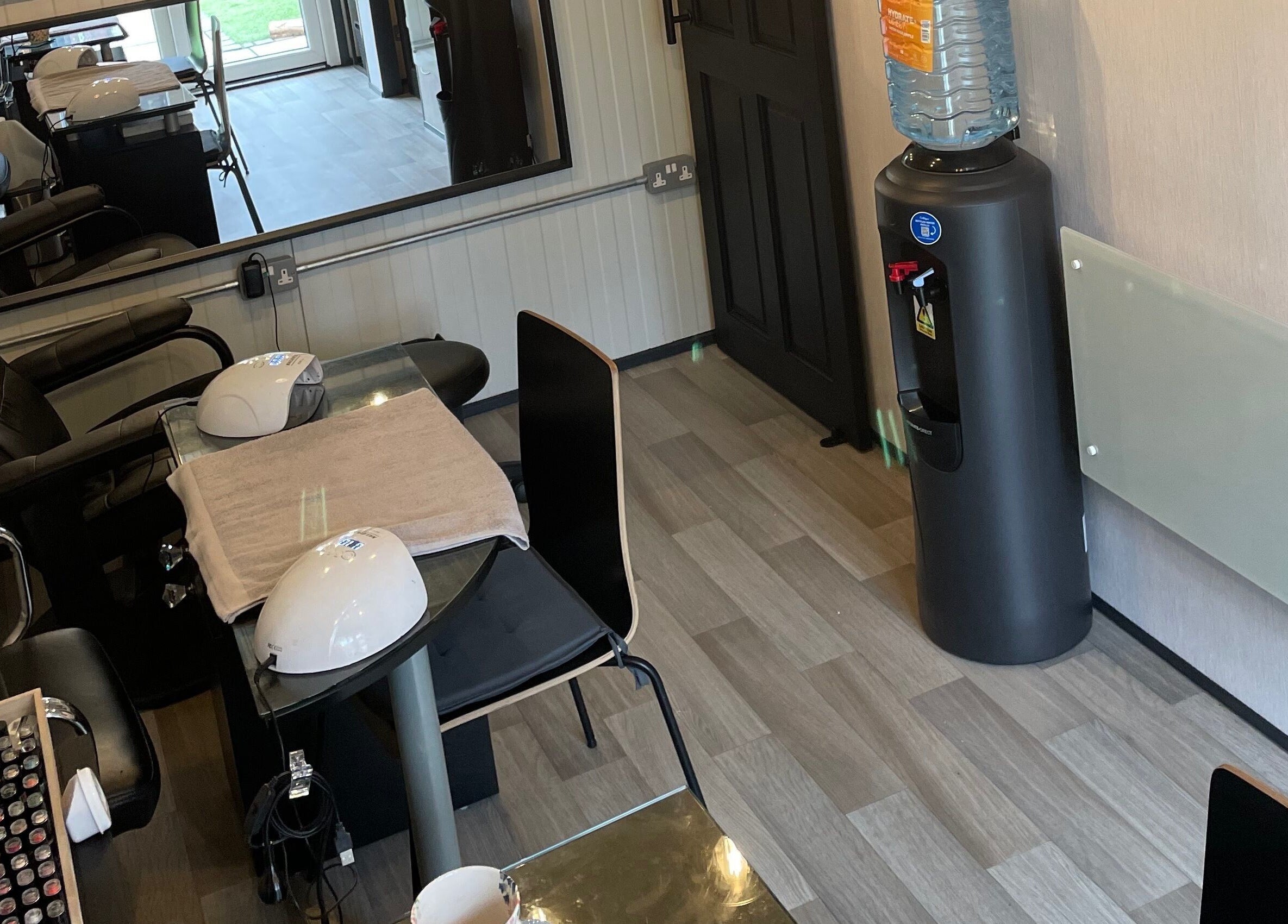 Modern nail station at Polished of Swinton, Swinton, England, GB featuring stylish chairs and equipment.
