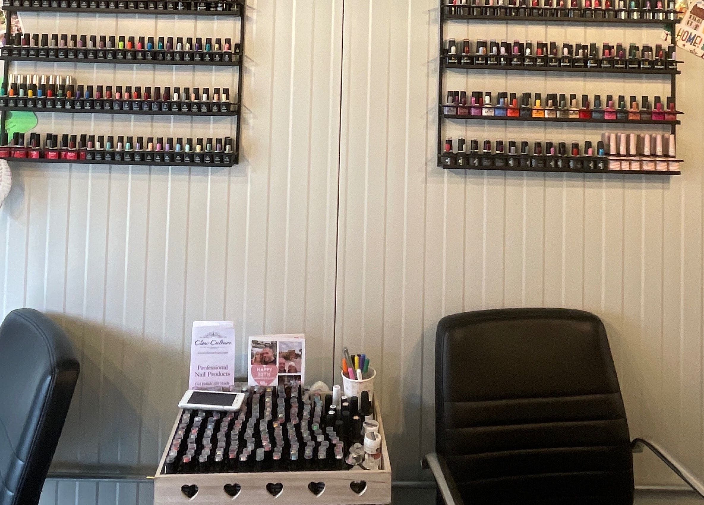Polished of Swinton nail varnish display and chairs in Swinton, England, GB, showcasing diverse colors.