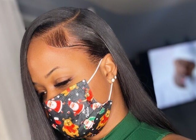 Elegant woman with sleek hairstyle at Justslay Beauty Crib, Ellerton, Saint George, BB, wearing a festive mask.
