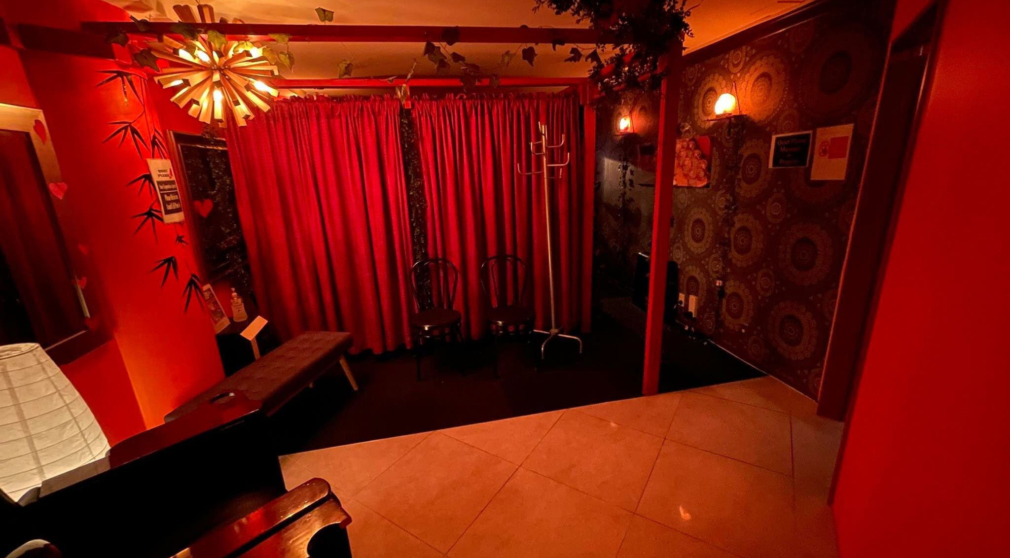 Relaxing interior of Bamboo Spa Christchurch Central with ambient red lighting in Christchurch, Canterbury, NZ.