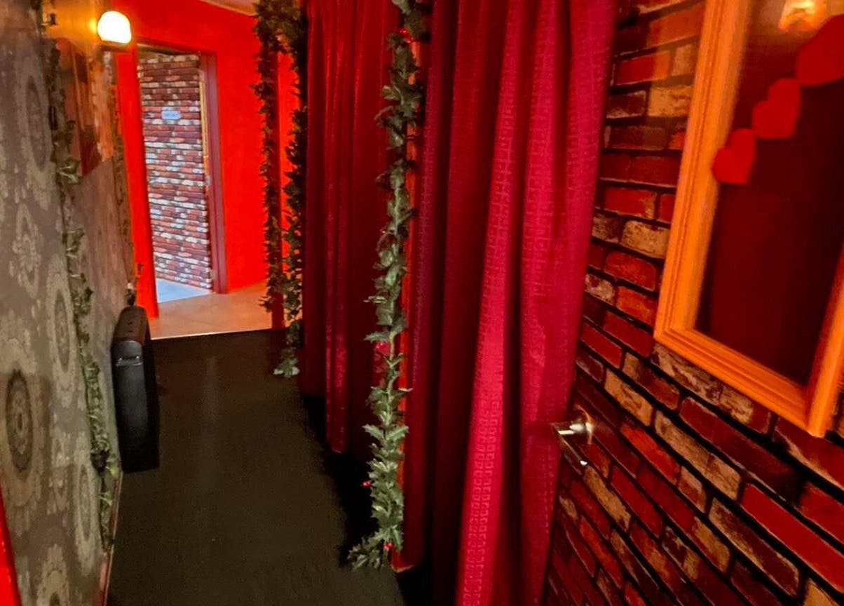 Vibrant red hallway with draped curtains at Bamboo Spa Christchurch Central in Christchurch, Canterbury, NZ.
