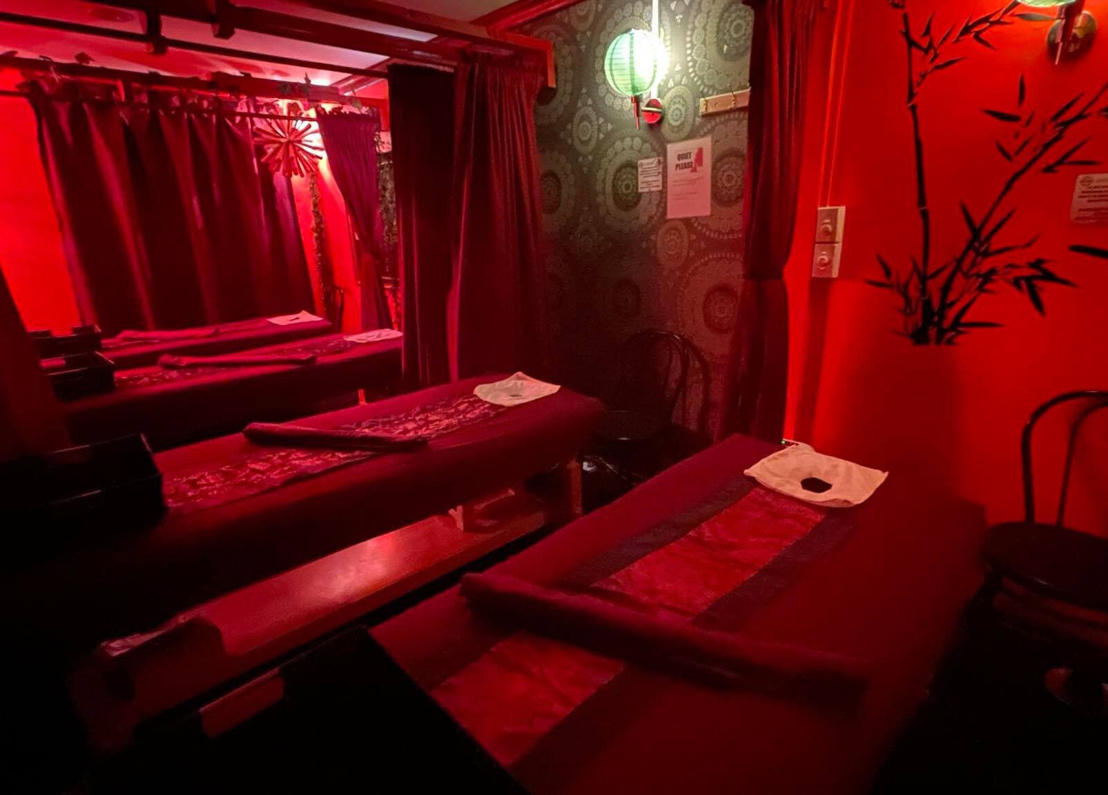 Tranquil massage room at Bamboo Spa Christchurch Central, Christchurch, Canterbury, NZ, with elegant red decor.