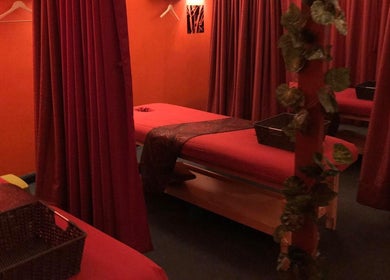 Tranquil massage room at Bamboo Spa Christchurch Central, Christchurch, Canterbury, NZ with red curtains and decor.