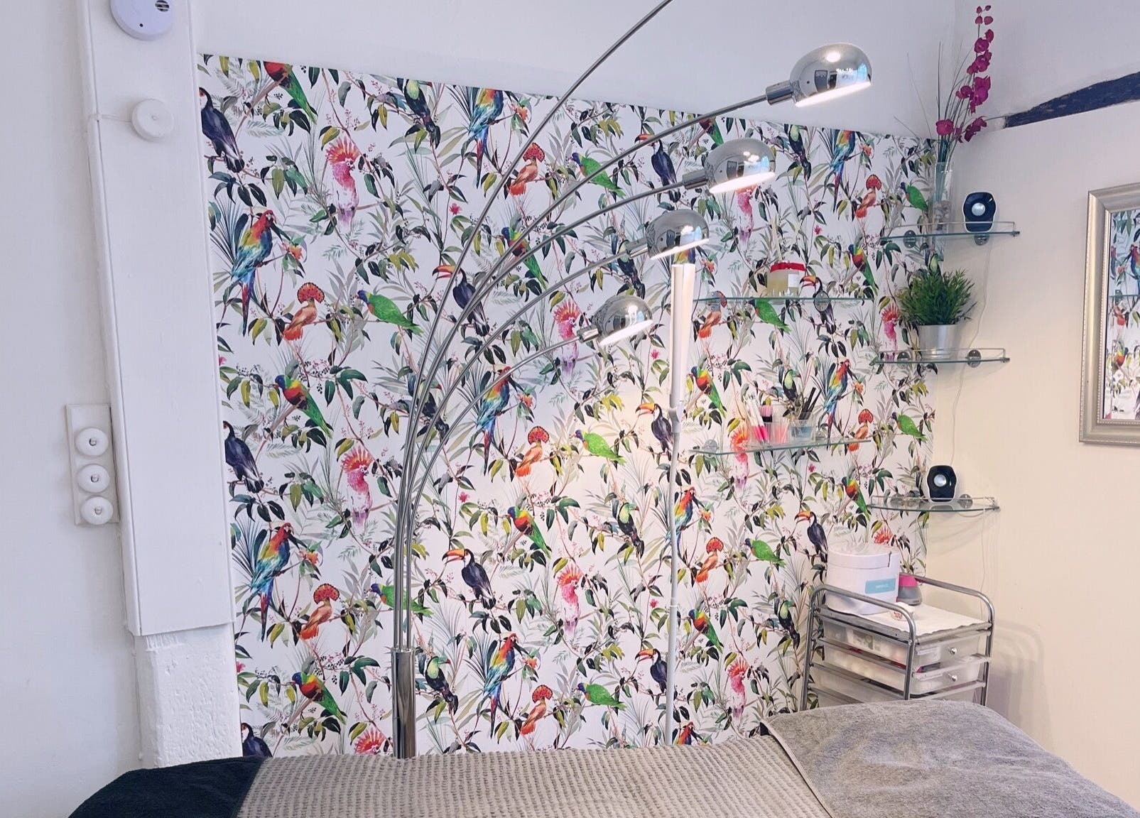 Chic beauty room with bird-patterned wallpaper at Gemma Sharpe Organic, Midhurst, England, GB.