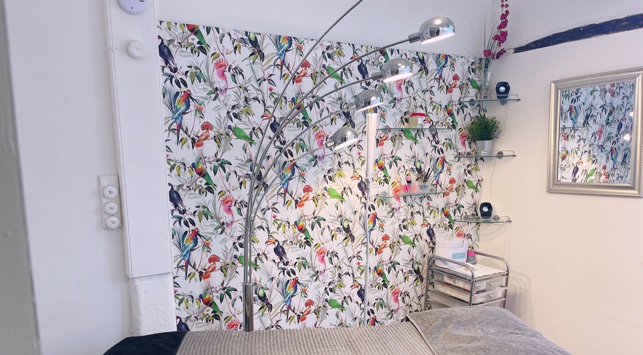 Chic beauty room with bird-patterned wallpaper at Gemma Sharpe Organic, Midhurst, England, GB.