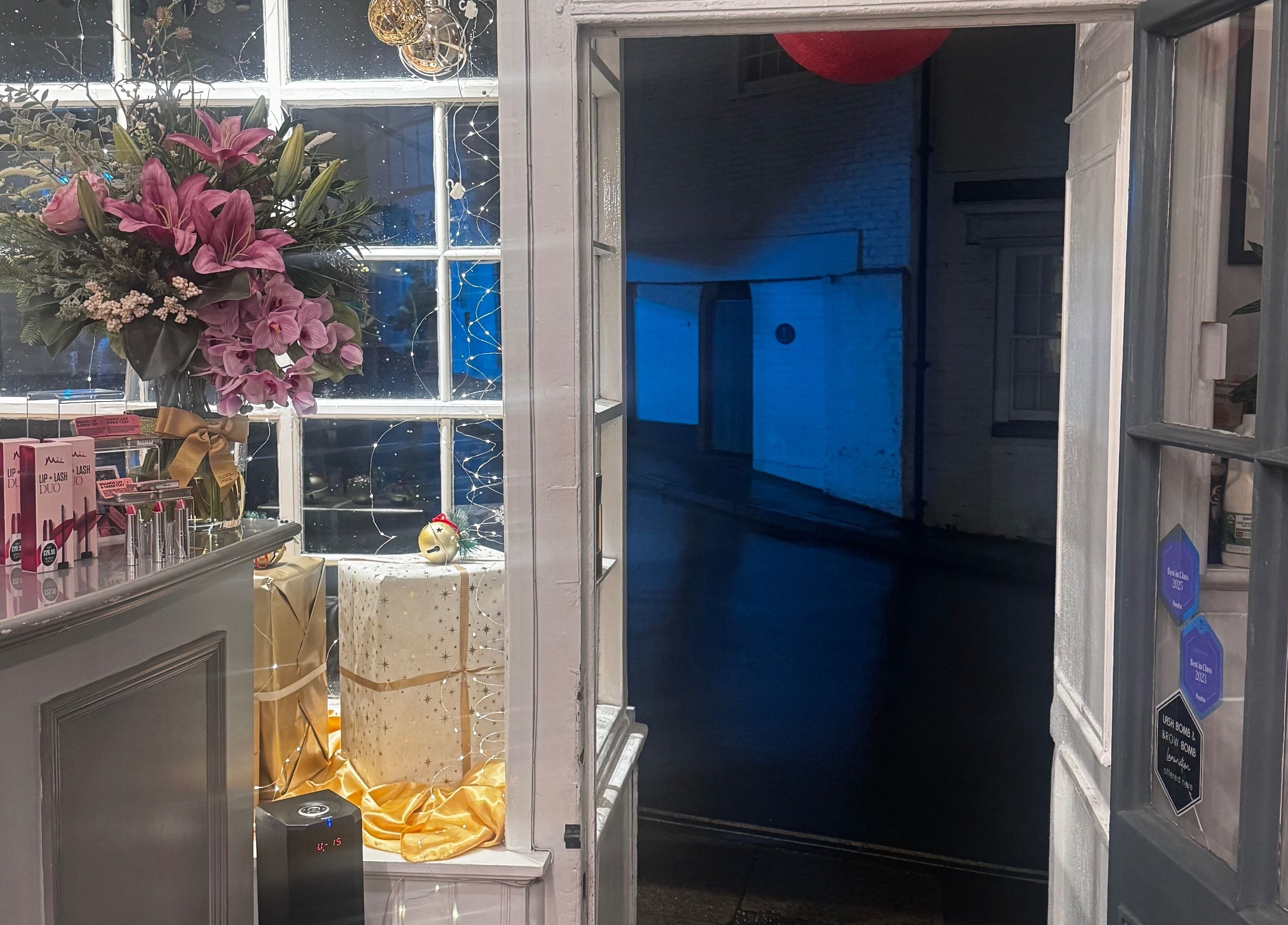 Entrance of Gemma Sharpe Organic, Midhurst, England, GB featuring a vibrant bouquet and beauty products.