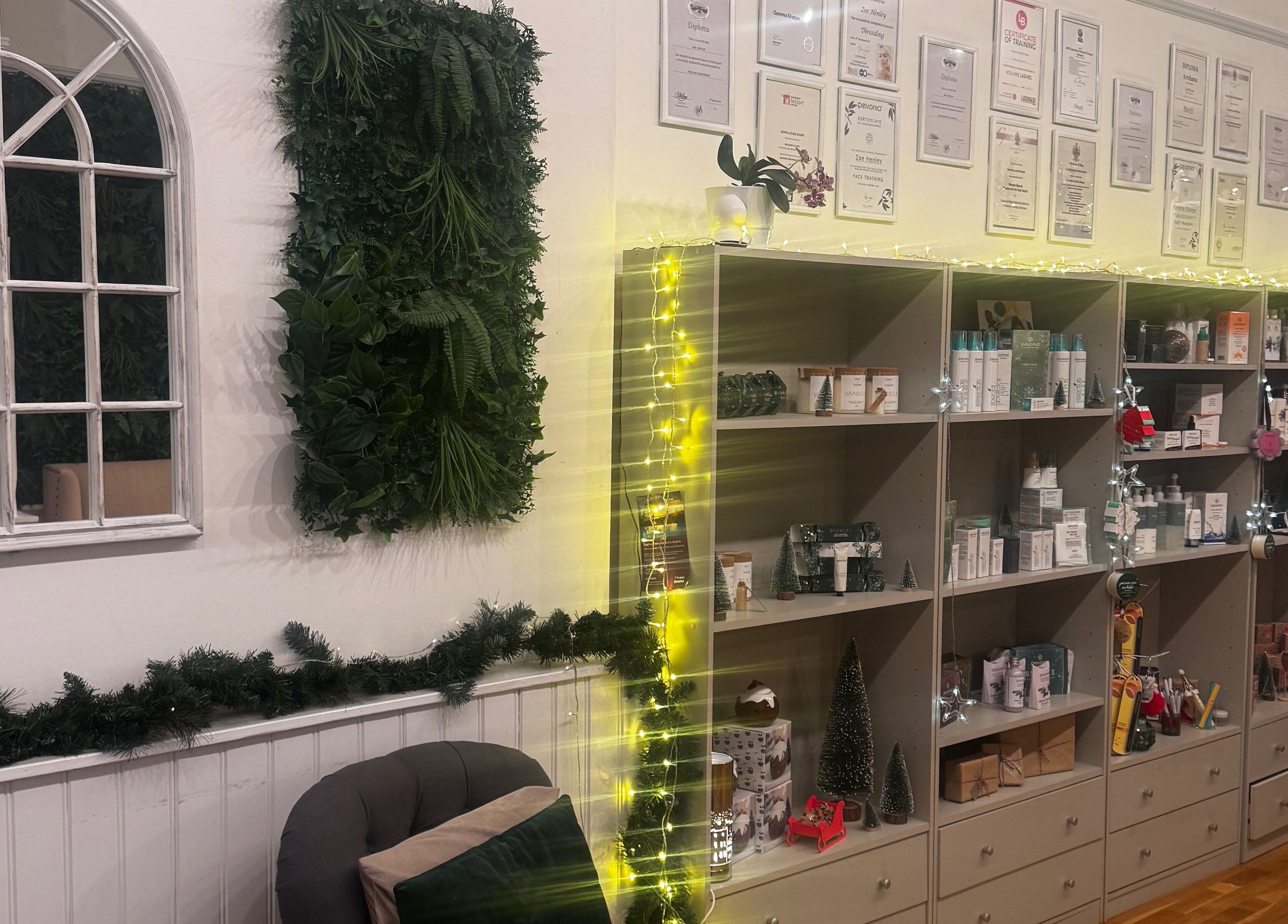 Calming shelves at Gemma Sharpe Organic, Midhurst, England, GB, adorned with products and greenery.