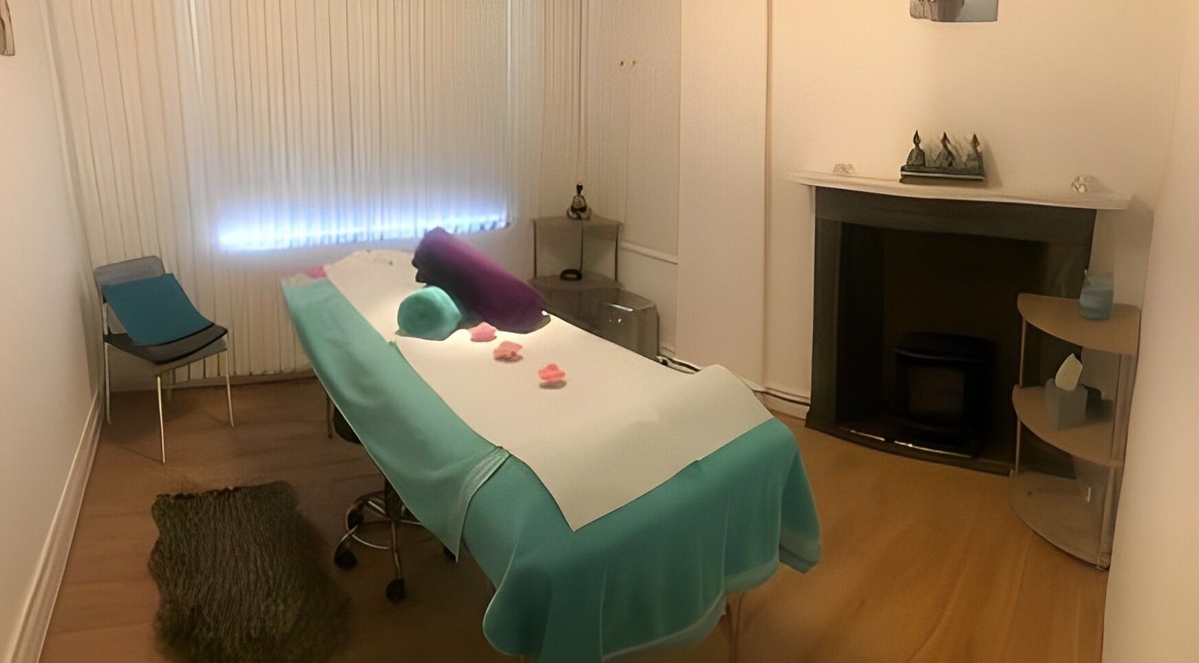 Relaxing massage room at Escape Spa and Massage, Worcester, England, GB, featuring a cozy treatment bed and ambient lighting.