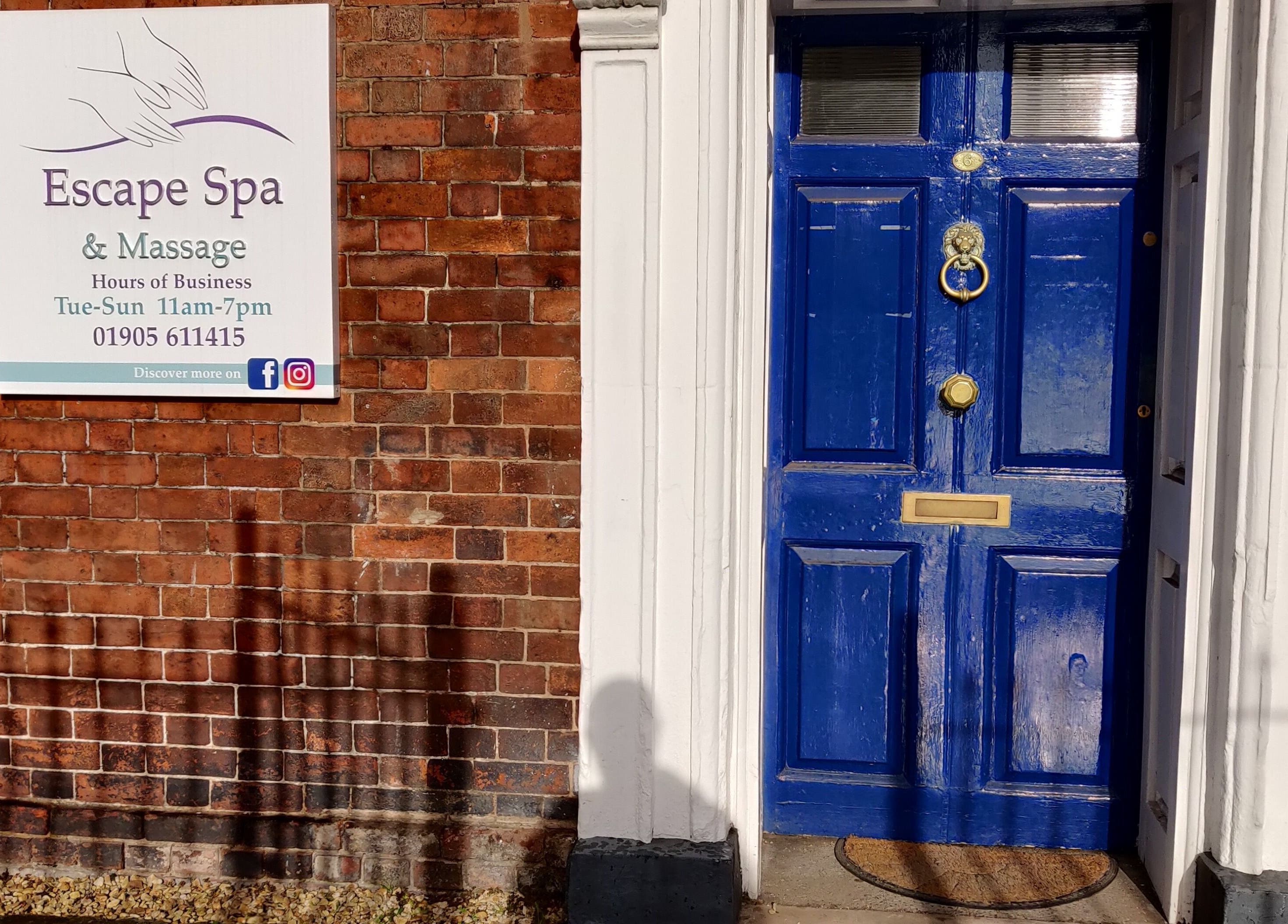 Charming blue door at Escape Spa and Massage, Worcester, England, GB, inviting relaxation and wellness.