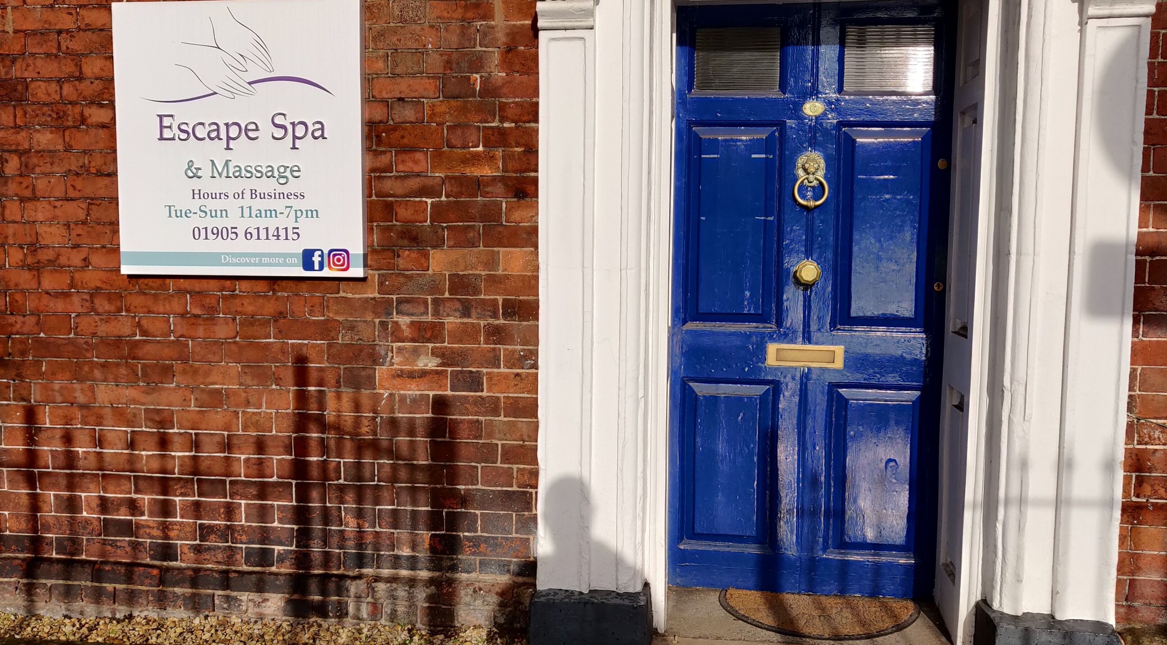 Charming blue door at Escape Spa and Massage, Worcester, England, GB, inviting relaxation and wellness.