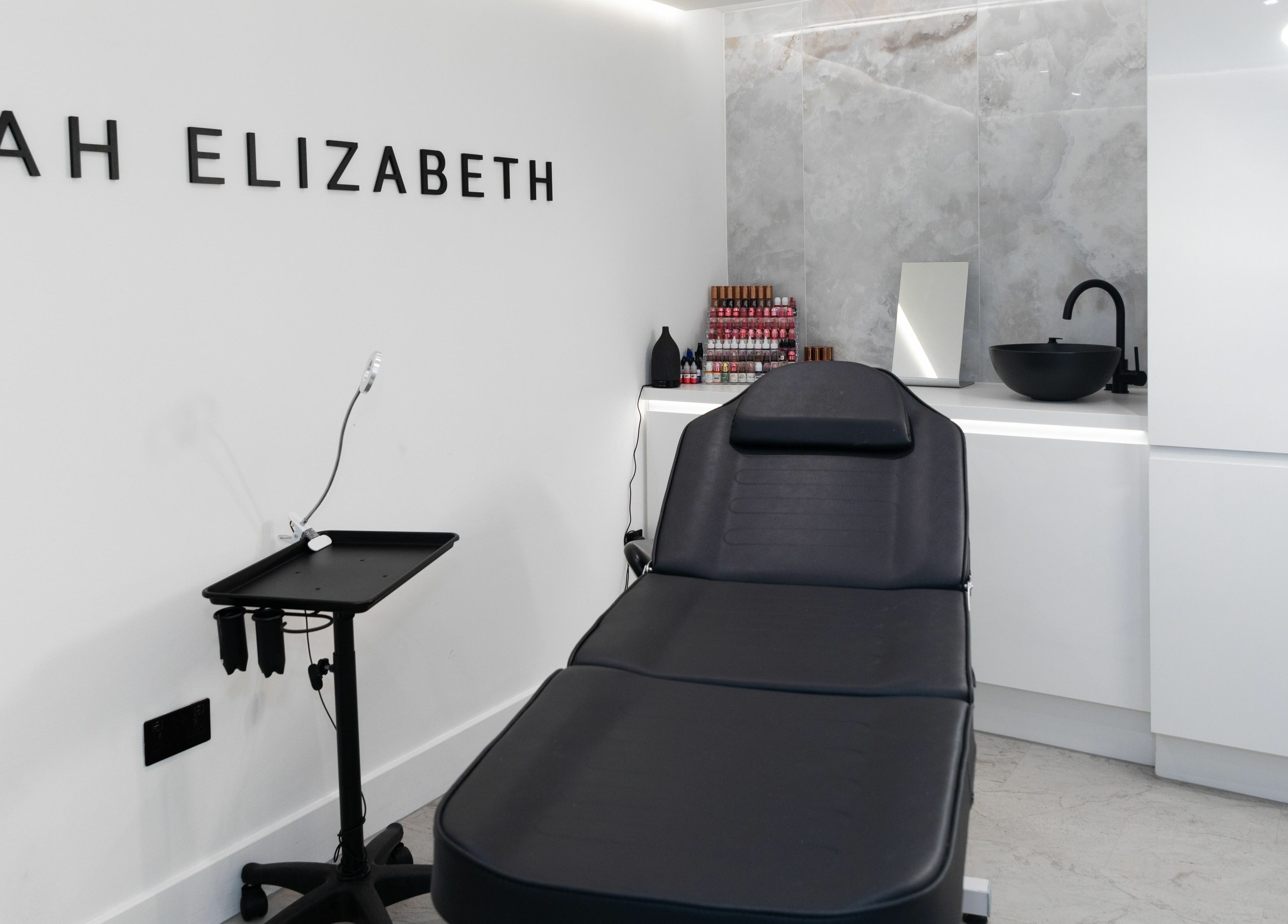 Modern treatment room at Elizabeth May Studios, Orpington, England. Features a sleek chair and calming decor.