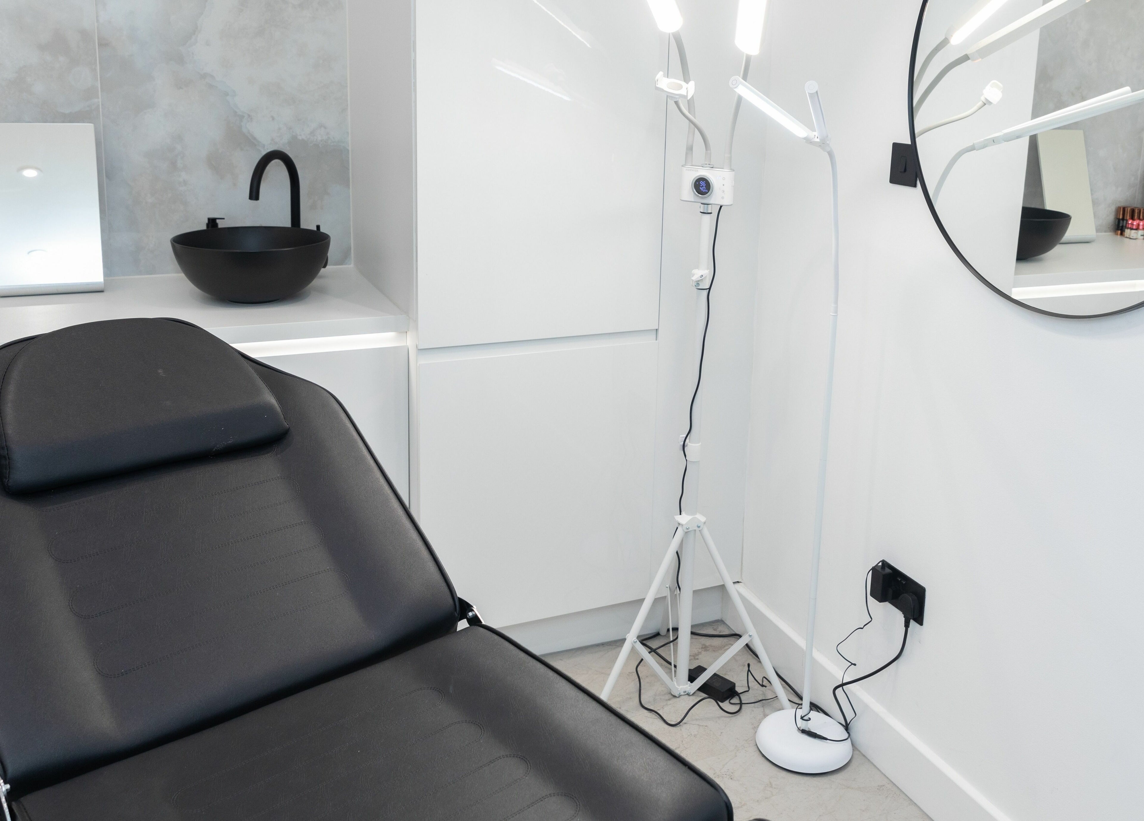 A sleek beauty treatment room at Elizabeth May Studios, Orpington, England, GB with stylish décor.