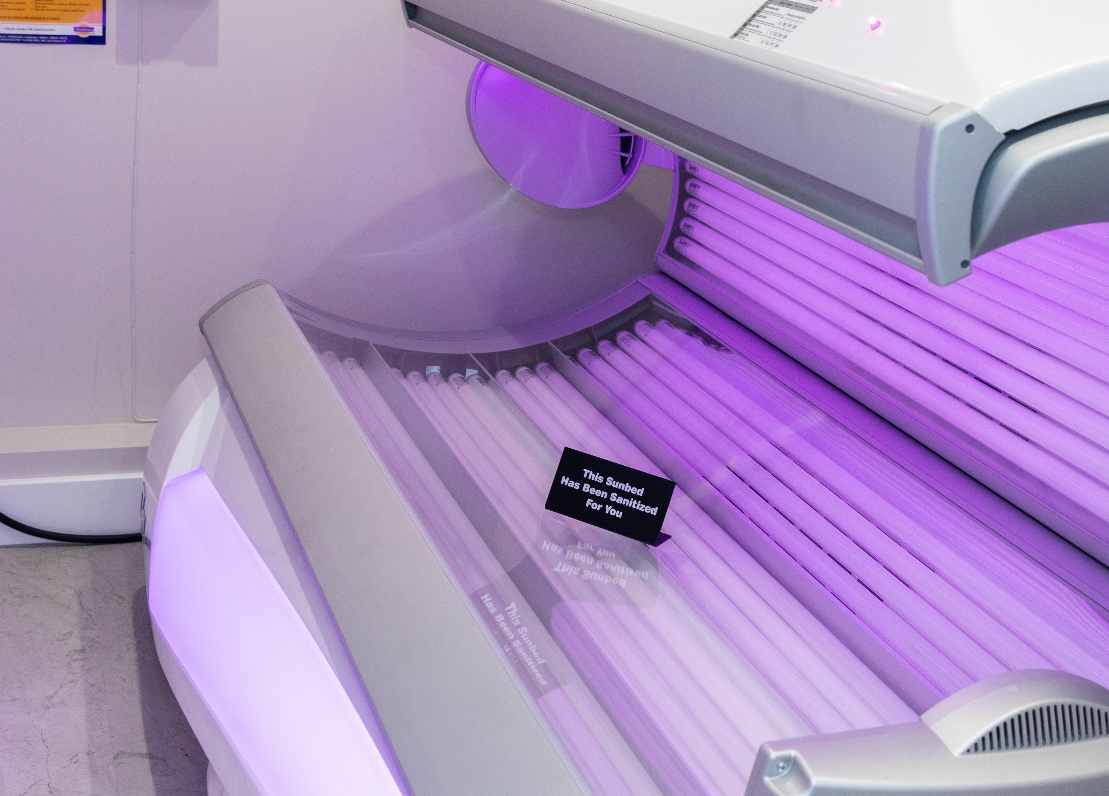 Sanitized sunbed glowing at Elizabeth May Studios, Orpington, England, GB, offering safe tanning experience.