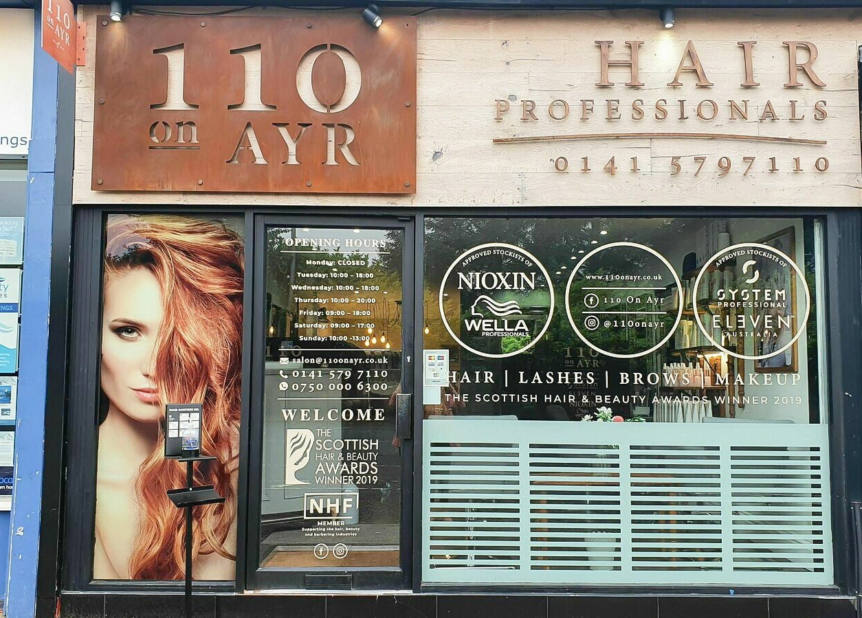 Front view of 110 On Ayr Hair Salon in Glasgow, Scotland, GB showcasing elegant signage and model imagery.