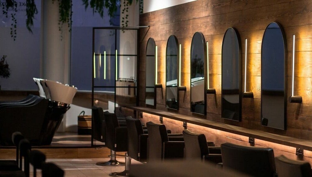 Elegant salon interior at Taylor Cole, Truro, England, GB, featuring stylish mirrors and seating.