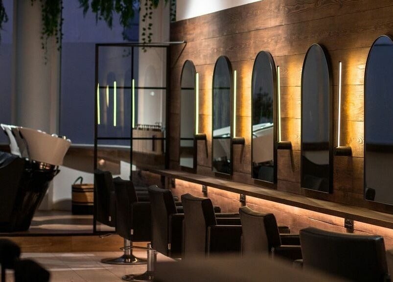 Elegant salon interior at Taylor Cole, Truro, England, GB, featuring stylish mirrors and seating.