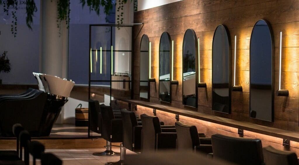 Elegant salon interior at Taylor Cole, Truro, England, GB, featuring stylish mirrors and seating.